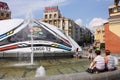 People relax by the fountain near EURO 2012 ball