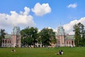 People relax on the lawn and have a picnic near the historic building. Russia, Moscow, Tsaritsyno - 09 01 2019