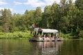 People relax on a primitive raft during a rafting on River. Tourists rafting, floating. Russia, Bashkortostan, July 2019