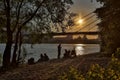 People relax on the river bank at sunset Royalty Free Stock Photo