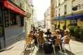 People relax in a street cafe. Amelie film location. Montmartre, Paris, France.