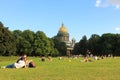 People relax in the summer on the grass in front of St. Isaac's Cathedral. tourist Saint Petersburg
