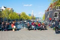 People relax in the sun, famous Cafe de Sluyswacht on the left, Montelbaans Tower is visible in the background.