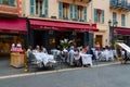 People relax at tables in outdoor French restaurant Le Grand Balcon in Old Town, Nice, France Royalty Free Stock Photo