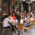 Friends relax at a cosy terrace in London Court, Perth, Australia Royalty Free Stock Photo