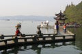 People relax along the Unesco West lake in Hangzhou, China