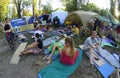 People relaxing around fest camp sitting lying on karemats. Festival Vedalife. Kyiv, Ukraine Royalty Free Stock Photo