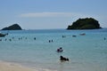 People relaxing on the beach.Tourists come and play the sea. Royalty Free Stock Photo