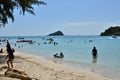 People relaxing on the beach.Tourists come and play the sea. Royalty Free Stock Photo