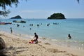 People relaxing on the beach. Tourists come and play the sea. Royalty Free Stock Photo