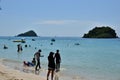 People relaxing on the beach.Tourists come and play the sea.