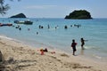 People relaxing on the beach.Tourists come and play the sea. Royalty Free Stock Photo