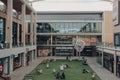 People relaxing in the courtyard of The Westgate Shopping Centre, Oxford, UK