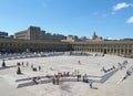 People relaxing and enjoying the summer sunshine in the square of halifax piece hall in west yorkshire