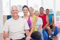 People relaxing on fitness balls in gym class Royalty Free Stock Photo