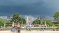 People relaxing in Tuileries Palace open air park near Louvre museum timelapse. Paris, France Royalty Free Stock Photo