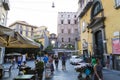 People relaxing and having a good tine on a terrace, ambulant merchant and tourist