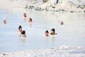 People relaxing in healthy mud pool at Aeolian Islands, Italy