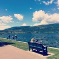 People relaxing on lake shore