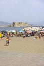 People relaxing on the Mappatella Beach by the Tyrrhenian Sea, Castel dell\'Ovo in the background, Naples,