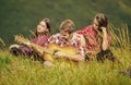 People relaxing on mountain top while handsome man playing guitar. Peaceful place. Melody of nature. Hiking tradition