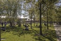 People relaxing in the New Holland island of the city, modern hipster place to spend weekend. Green lawn is full of families with