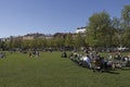 People relaxing in the New Holland island of the city, modern hipster place to spend weekend. Green lawn is full of families with