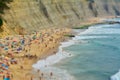 People relaxing On ocean portugal beach