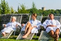 People relaxing on outdoor rest area of sauna