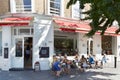 People relaxing in outdoor tables, near cafe in London