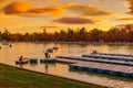 People relaxing in rowboats in the scenic pond of Buen Retiro Pa