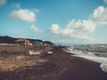 People relaxing by the sea. Splashing waves on a sandy beach. Summer sunny day on the seaside Royalty Free Stock Photo