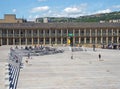 People relaxing on the steps and cafes and walking across the square of halifax piece hall in west yorkshire with a view of