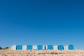 Pebbled beach and blue beach huts