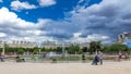 People relaxing in Tuileries Palace open air park near museum timelapse hyperlapse. Paris, France Royalty Free Stock Photo