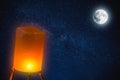 People Release Paper Fire Lamp rising over night sky full moon