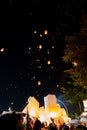 People releasing paper lanterns during Loi Krathong and Yi Peng festival Royalty Free Stock Photo