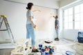 People renovating the house by painting the wall Royalty Free Stock Photo