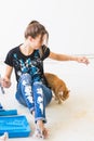 People, renovation and repair concept - Portrait of lovely young woman with cat doing redecoration in apartment Royalty Free Stock Photo