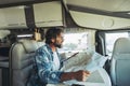 People renting vehicle for summer travel trip vacation. One man smiling happy sitting inside modern camper van motorhome with road Royalty Free Stock Photo