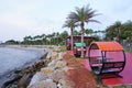 People rest at bench beside beach in Bang Phra, Si racha, Chonburi, Thailand