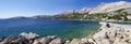 People rest on Laguna beach in the Historic Baska town on Krk Island on April 30, 2017. Croatia