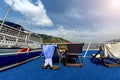 People rest lying in armchairs on the ship`s deck Royalty Free Stock Photo