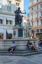 People rest near Joseph Fountain, or Fountain of Joseph the Betrothed, on Graben Street, Vienna, Austria