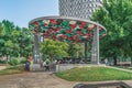 People rest in the park near Friendship Monument in the Tirana center