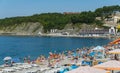 People rest on the rocky beach of the village of Olginka. Beach vacation in early September. Tuapse