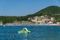 People rest on the rocky beach of the village of Olginka. Beach vacation in early September. Tuapse