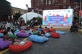 People rest sitting on the colorful soft chairs.