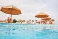 People resting near swimming pool