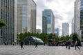 People resting outdoors and entering underground station after a working day at Canary Wharf. UK September 2019.